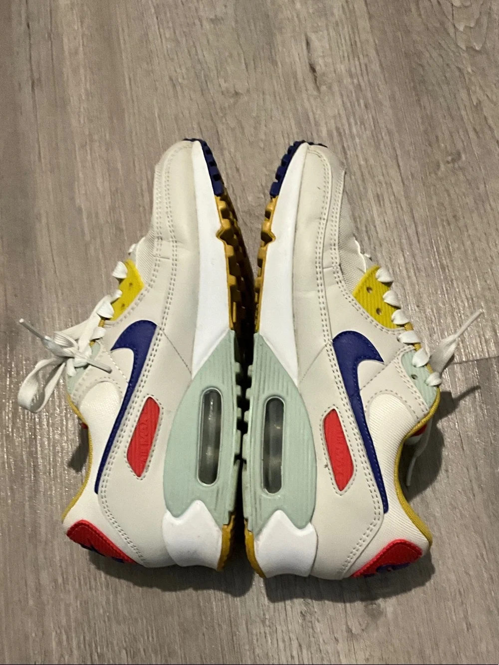 Nike White Sneakers with Blue, Yellow and Red Accents
